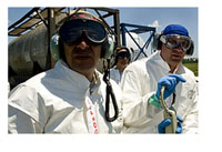 A team of U.S. Air Force aerial spray aircraft maintainers