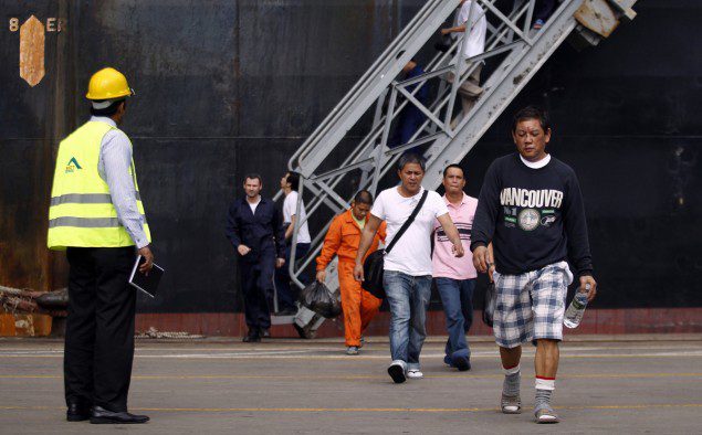 Crew members from Mitsui O.S.K. Lines' MOL Comfort, a container ship that broke into two in the Indian Ocean, disembark from a ship at a port in Colombo June 20, 2013.