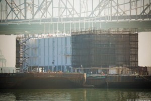 The mystery barge at Treasure Island below the SF-Oakland Bay Bridge. Photo credit: James Martin/CNET