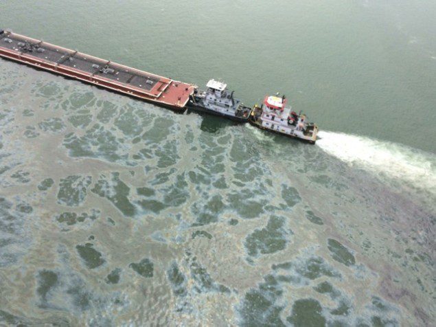 A tank barge leaks fuel oil following a collision with a bulk carrier, March 22, 2014 in the Houston Ship Channel. U.S. Coast Guard Photo
