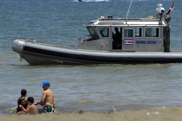 A Coast Guard boat warns bathers of the dangers of swimming in the sea in Puntarenas May 3, 2015. 