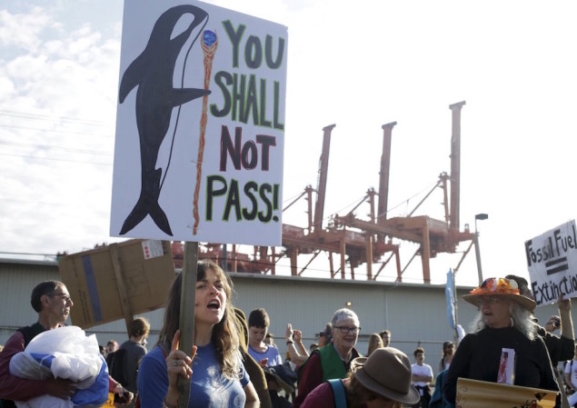 Activists march and rally at the entrance of Terminal 5 to protest Shell Oil Company's drilling rig Polar Pioneer which is parked at the Port of Seattle, Washington May 18, 2015. U.S. Coast Guard Photo