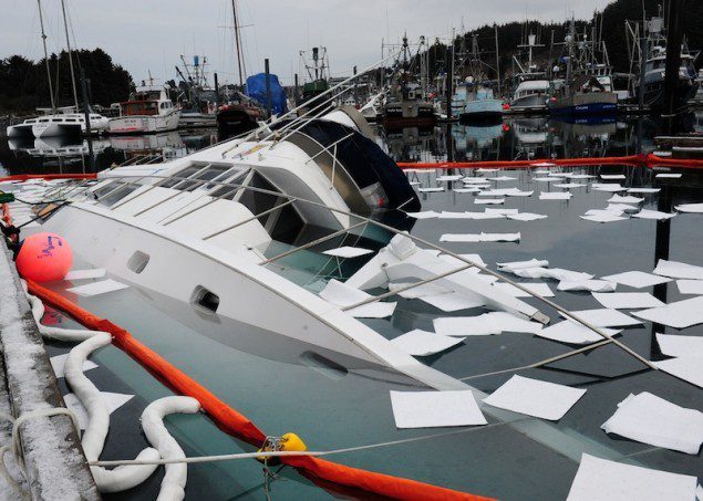 Absorbant pads and oil boom float around the U.S. Fish and Wildlife Service research vessel Arluk after it sank at the pier in St. Herman's harbor in Kodiak, Alaska, Feb. 8, 2012. Coast Guard Marine Safety Detachment Kodiak personnel responded to the sinking and are assisting with pollution mitigation and salvage of the vessel. U.S. Coast Guard photo by Petty Officer 3rd Class Jonathan Klingenberg.