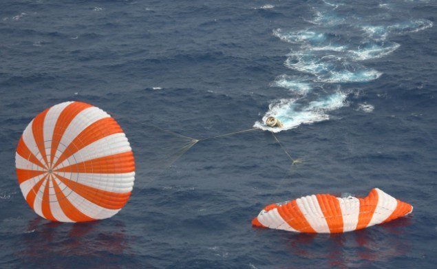 Dragon spacecraft and two of the three main parachutes shortly after splashdown, May 31, 2012. Courtesy NASA