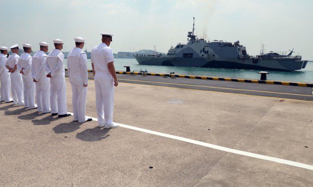 SINGAPORE (April 18, 3013) Sailors attached to Forward Liason Element, USS Freedom (LCS 1), observe Freedom as it arrives in Singapore during an eight-month deployment to Southeast Asia. US Navy Photo