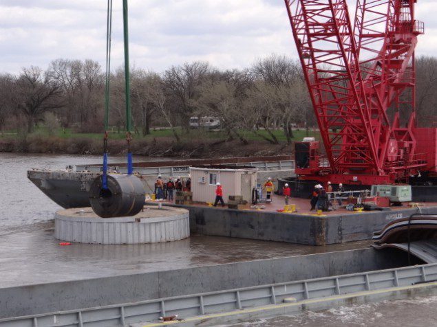 A large crane known as the "HERCULES" offloads rolled coils from one of the submerged barges near the Marseilles Dam in Marseilles, Ill., April 25, 2013. Read more: http://www.dvidshub.net/image/915356/salvage-operators-remove-three-more-barges-near-marseilles-dam#.UXqx_StATeo#ixzz2Rac01cvJ