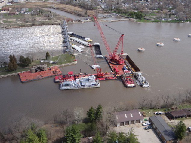 A crane known as the "HERCULES" unloads cargo from one of the submerged barges near the Marseilles Dam in Marseilles, Ill., April 24, 2013. Read more: http://www.dvidshub.net/image/915358/salvage-operations-continue-near-marseilles-dam#.UXqrqytATeo#ixzz2Rab8z2xX