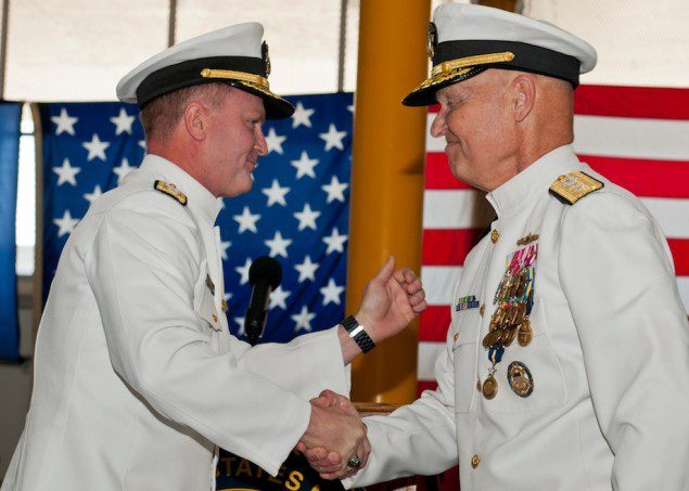 Rear Adm. T. K. Shannon (left) and Rear Adm. Mark Buzby congratulate each other during a change of command ceremony aboard the USNS Spearhead (JSHV 1). Shannon relieved Buzby as commander, Military Sealift Command. U.S. Navy Photo by Mass Communication Specialist Seaman Apprentice Jesse A. Hyatt