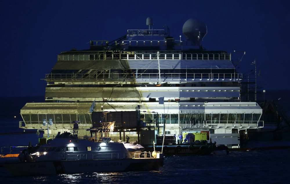 The capsized cruise liner Costa Concordia is seen at the end of the "parbuckling" operation outside Giglio harbour September 17, 2013. REUTERS/Tony Gentile