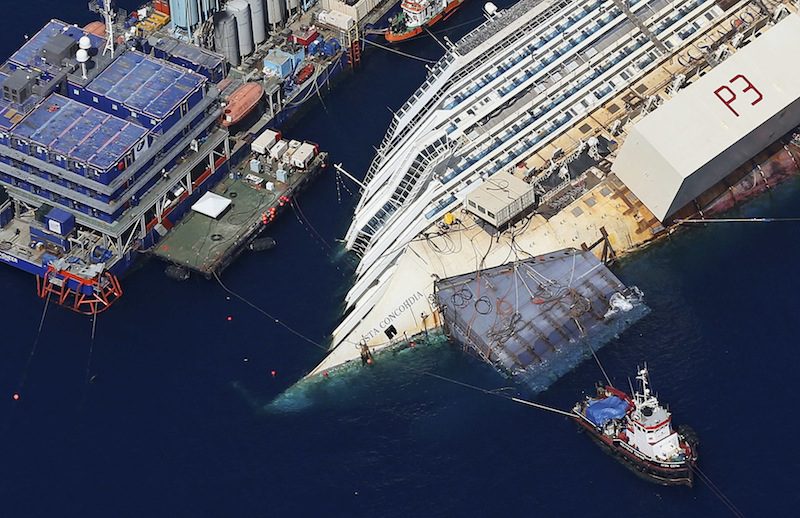 An aerial view shows the Costa Concordia as it lies on its side next to Giglio Island taken from an Italian navy helicopter August 26, 2013. REUTERS/Alessandro Bianchi