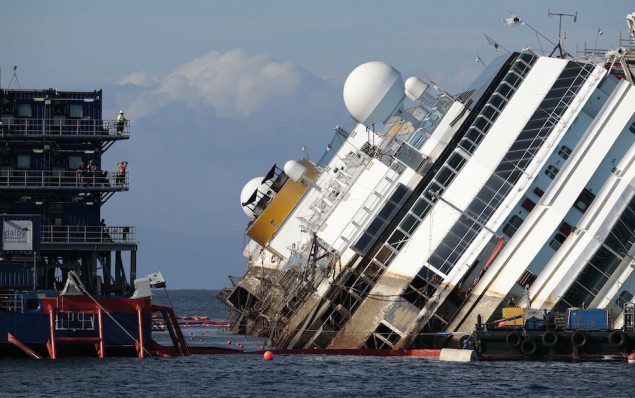Salvage crew looks at the capsized cruise liner Costa Concordia during the "parbuckling" operation, outside Giglio harbour September 16, 2013. REUTERS/Tony Gentile