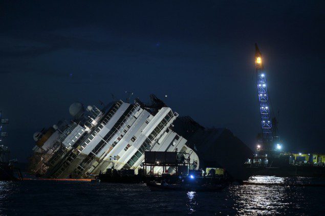 The capsized cruise liner Costa Concordia lies on its side next to Giglio Island September 16, 2013. REUTERS/Tony Gentile