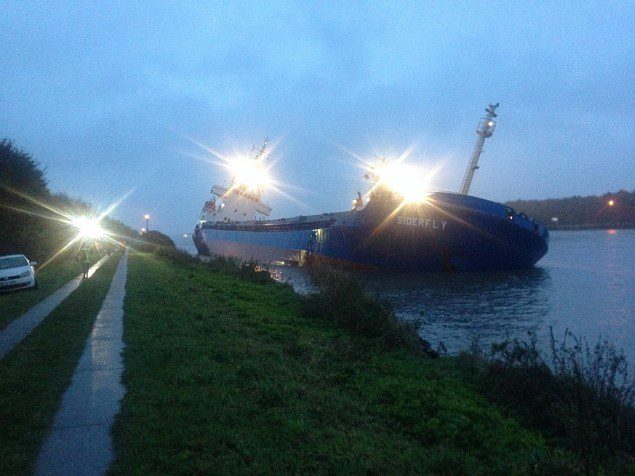 The MV Siderfly seen listing heavily along an embamkment of Germany's Kiel Canal.