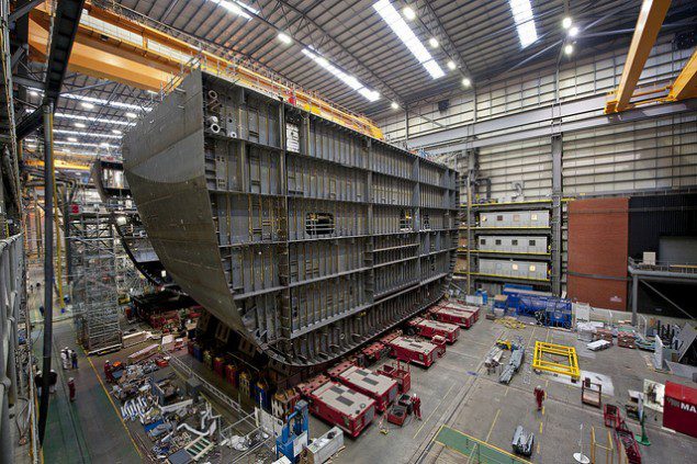 Workers move the first two sections of the 6,000 tonne block of QE class under construction in Portsmouth together for the first time. Image (c) BAE Systems plc