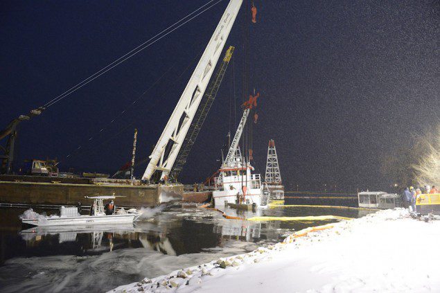 Response crews rig sling to Stephen L. Colby in snowy conditions
