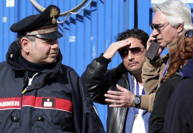 Schettino, the captain of the Costa Concordia, gestures after going back on board the cruise liner at Giglio harbour