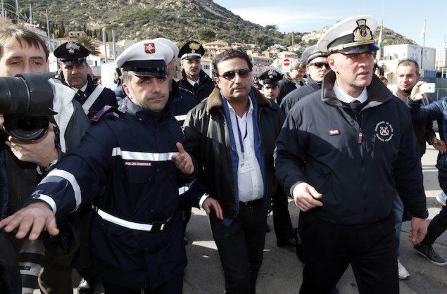 Schettino, the captain of the Costa Concordia, arrives after going back on board the cruise liner at Giglio harbour