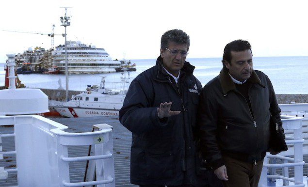 Schettino, the captain of the Costa Concordia cruise liner, boards a ferry as he leaves Giglio harbour