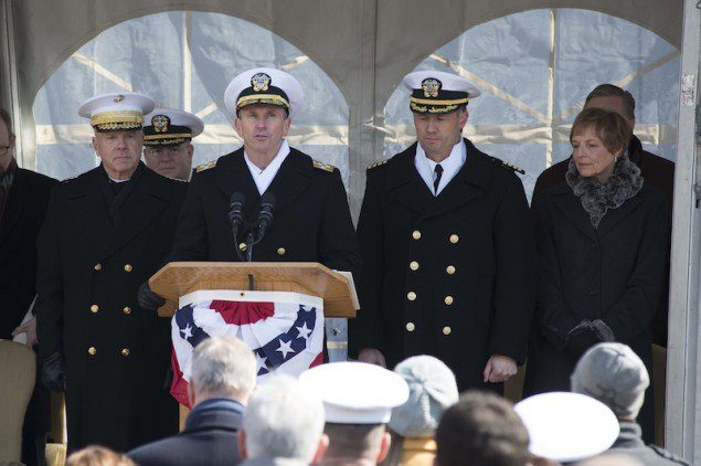 140301-N-WL435-400 PHILADELPHIA (March 1, 2014) Chief of Naval Operations (CNO) Adm. Jonathan Greenert is joined at the podium by Commandant of the Marine Corps Gen. James Amos, USS Somerset (LPD 25) Commanding Officer Capt. Thomas Dearborn and ship's sponsor Mary Jo Myers as he gives to order to place Somerset in commission during the commissioning ceremony of the San Antonio class amphibious transport dock March 1. U.S. Navy Photo