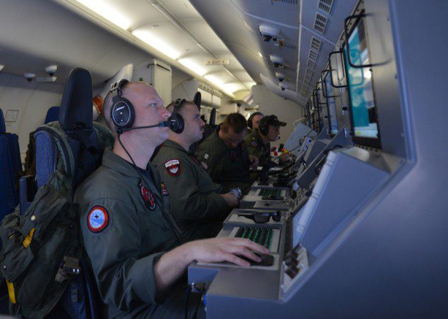 Crew members on board a P-8A Poseidon assigned to Patrol Squadron (VP) 16 man their workstations while assisting in search and rescue operations for Malaysia Airlines flight MH370, March 16, 2014. U.S. Navy Photo