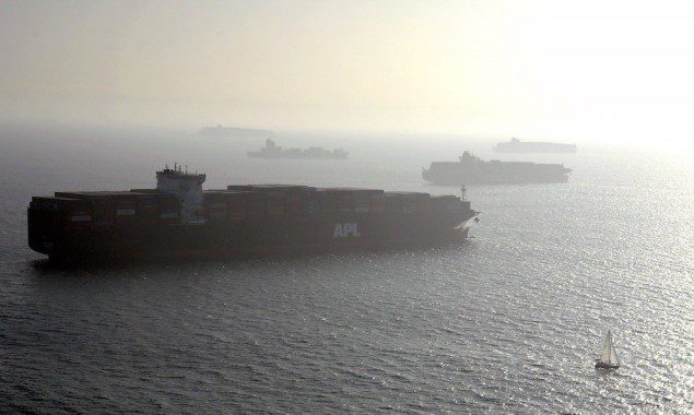 Ships gather off the ports of Los Angeles and Long Beach, California as a sailboat makes it way past them in this aerial photo taken February 6, 2015. REUTERS/Bob Riha Jr