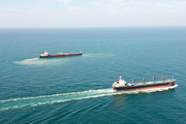 A vessel transits the Galveston Fairway passing the SN Federica, after it ran aground 35 miles off Galveston, March 31, 2015. U.S. Coast Guard Photo