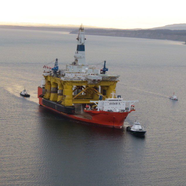 Coast Guard crews escort the 674-foot Curacao-flagged semi-submersible heavy lift ship Blue Marlin to its anchorage location in Port Angeles Bay, Wash., April 17, 2015. U.S. Coast Guard Photo