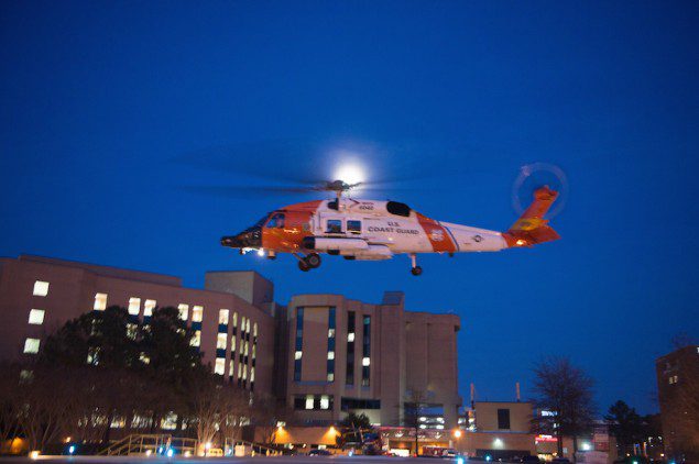 A Coast Guard MH-60 Jayhawk helicopter crew lands at Sentara Norfolk General Hospital in Norfolk, Va., Thursday, April 2, 2015, after medevacing a sailor who had been missing for more than 60 days. U.S. Coast Guard Photo