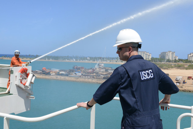 Petty Officer 1st Class Gary Bullock, a port state control officer at Coast Guard Sector Honolulu Prevention, observes crew members demonstrating firefighting capabilities aboard the 600-foot Panamanian flagged bulk freight ship, Teizan, at Kalaeloa Barbers Point Harbor, May 19, 2015. Coast Guard crew members conduct inspections to ensure a vessel has a suitable structure, correct documentation, proper working equipment and lifesaving equipment and adequate accommodations. (U.S. Coast Guard photo by Petty Officer 2nd Class Tara Molle)