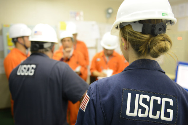 Tim Wilcox and Petty Officer 2nd Class Cindy Washburn, port state control officers at Coast Guard Sector Honolulu Prevention, speak with crew members during an inspection of the engine room aboard the 600-foot Panamanian-flagged bulk freight ship Teizan, at Kalaeloa Barbers Point Harbor, May 19, 2015. Coast Guard crew members conduct inspections to ensure a vessel has a suitable structure, correct documentation, proper working equipment and lifesaving equipment, and adequate accommodations. (U.S. Coast Guard photo by Petty Officer 2nd Class Tara Molle)