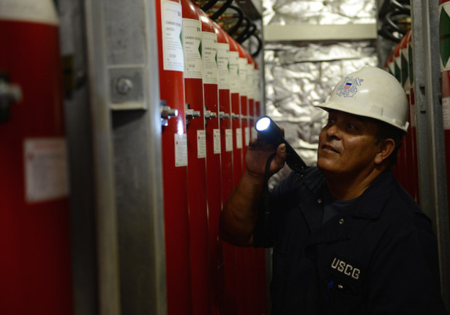 Tim Wilcox, a port state control officer at Coast Guard Sector Honolulu Prevention, inspects carbon dioxide tanks aboard the 600-foot Panamanian-flagged bulk freight ship Teizan, at Kalaeloa Barbers Point Harbor, May 19, 2015. Coast Guard crew members conduct inspections to ensure a vessel has a suitable structure, correct documentation, proper working equipment and lifesaving equipment, and adequate accommodations. (U.S. Coast Guard photo by Petty Officer 2nd Class Tara Molle)