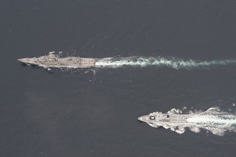 The Oliver Hazard Perry-class guided-missile frigate USS Rodney M. Davis (FFG 60), top, and the Royal Brunei Navy Darussalam-class offshore patrol vessel KDB Darulaman (PV 08) conduct maneuvering exercises while participating in Cooperation Afloat Readiness and Training (CARAT) Brunei 2014.