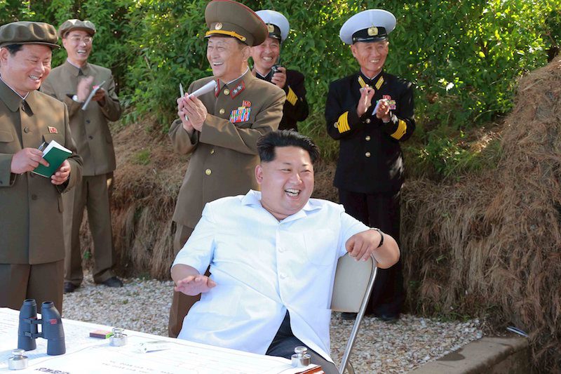 KCNA picture shows North Korean leader Kim Jong Un watching a test-firing drill of anti-ship missiles at sea
