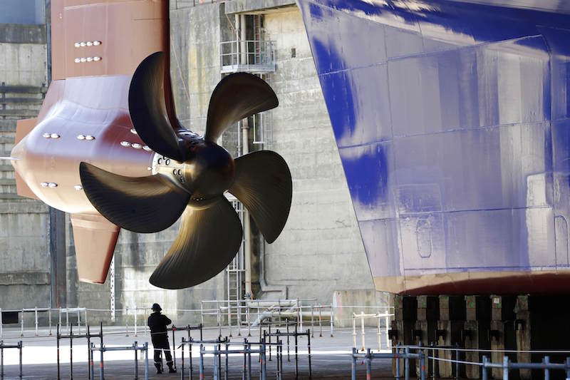 A security member is seen near a propeller of the Harmony of the Seas ( Oasis 3 ) class ship at the STX Les Chantiers de l'Atlantique shipyard site in Saint-Nazaire, France, June 17, 2015. REUTERS/Stephane Mahe