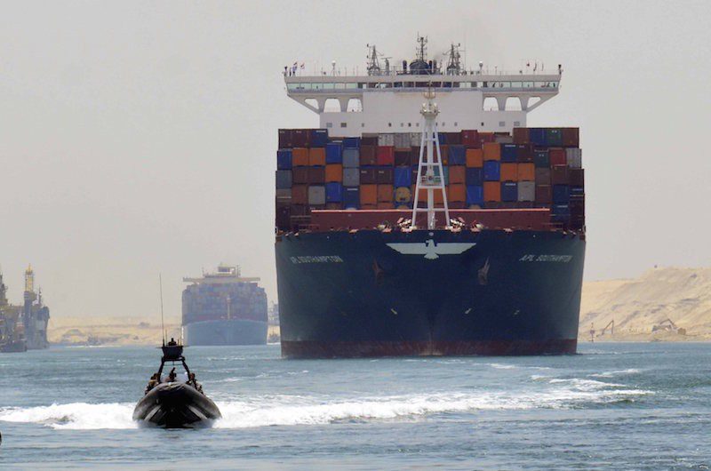 A cargo ship is seen crossing through the New Suez Canal, Ismailia, Egypt, July 25, 2015. The first cargo ships passed through Egypt's New Suez Canal on Saturday in a test-run before it opens next month, state media reported, 11 months after the army began constructing the $8 billion canal alongside the existing 145-year-old SuezCanal. Mohab Mameesh, chairman of the Suez Canal Authority overseer of the project, told state television that this test-run had been a success and that more would follow. REUTERS/Stringer      TPX IMAGES OF THE DAY
