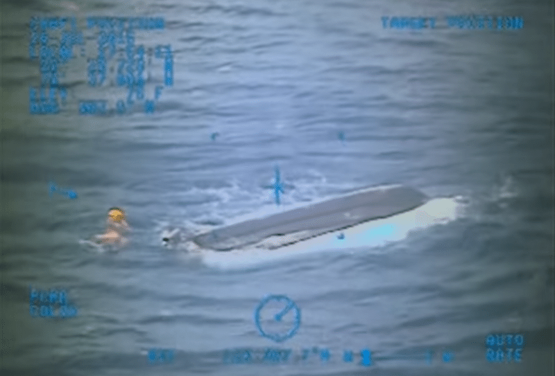 A U.S. Coast Guard rescue swimmer inspects the 19-foot boat belonging to the boys, Sunday, July 26, 2015. U.S. Coast Guard Photo
