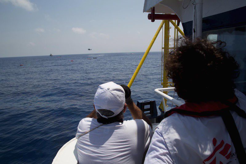 Medecins san Frontiere (MSF) Field coordinator Juan and first officer Porfirio follow the rescue operation involving ships and sea rescue helicopters, scanning the area to spot survivors in the water where a boat carrying migrants capsized and sank with many feared drowned off the coast of Libya August 5, 2015. A boat packed with up to 700 African migrants capsized in the Mediterranean Sea off the coast of Libya on Wednesday and many were feared dead, officials and aid agencies said. REUTERS/Marta Soszynska/MSF/ HandoutATTENTION EDITORS - NO SALES. NO ARCHIVES. FOR EDITORIAL USE ONLY. NOT FOR SALE FOR MARKETING OR ADVERTISING CAMPAIGNS. THIS IMAGE HAS BEEN SUPPLIED BY A THIRD PARTY. IT IS DISTRIBUTED, EXACTLY AS RECEIVED BY REUTERS, AS A SERVICE TO CLIENTS. REUTERS IS UNABLE TO INDEPENDENTLY VERIFY THE AUTHENTICITY, CONTENT, LOCATION OR DATE OF THIS IMAGE.