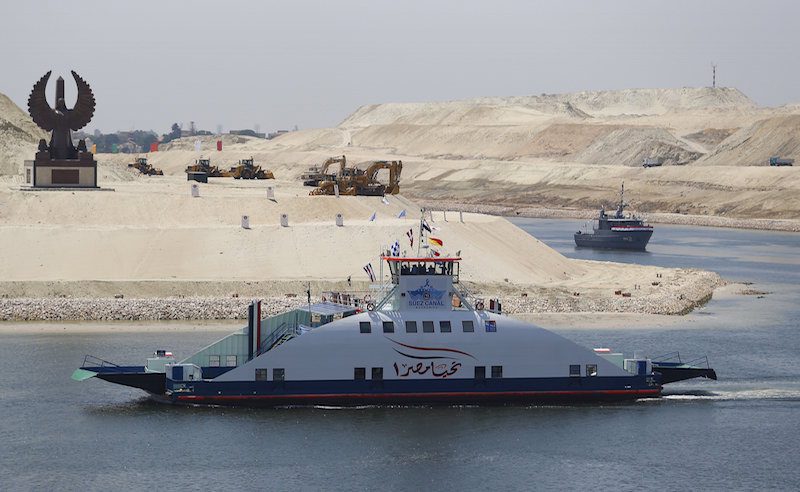 A ship named "Long life Egypt" crosses the new section of the Suez Canal after the opening ceremony of the new Suez Canal, in Ismailia