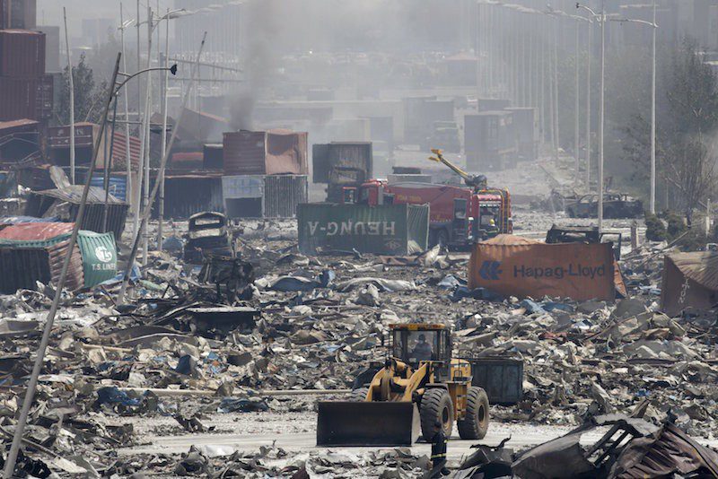 A bulldozer works near the site of the explosions at the Binhai new district, Tianjin, August 13, 2015. REUTERS/Jason Lee