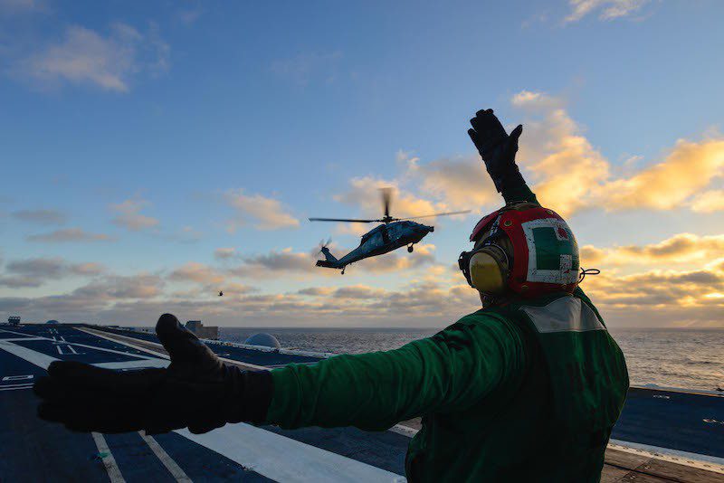 141209-N-TC437-407 PACIFIC OCEAN (Dec. 9, 2014) Aviation Machinist's Mate 2nd Class Jonathon Weimer, from Miami, directs an MH-60S Sea Hawk helicopter from the Chargers of Helicopter Sea Combat Squadron (HSC) 14 to the flight deck of the Nimitz-class aircraft carrier USS John C. Stennis (CVN 74). John C. Stennis is undergoing an operational training period in preparation for future deployments. (U.S. Navy photo by Mass Communication Specialist 3rd Class Ignacio D. Perez/ Released)