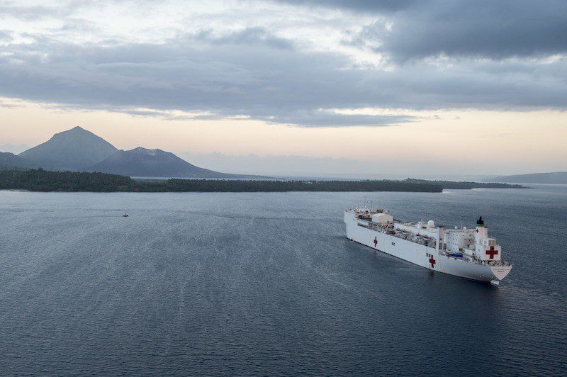 150706-N-BK290-719 RABAUL, Papua New Guinea (July 6, 2015) The Military Sealift Command hospital ship USNS Mercy (T-AH 19) sits at anchorage in Simpson Harbor off the coast of Rabaul, Papua New Guinea. Mercy is in Papua New Guinea for its second mission port of Pacific Partnership 2015. Pacific Partnership is in its tenth iteration and is the largest annual multilateral humanitarian assistance and disaster relief preparedness mission conducted in the Indo-Asia-Pacific region. (U.S. Navy photo by Chief Mass Communication Specialist Christopher E. Tucker/Released)