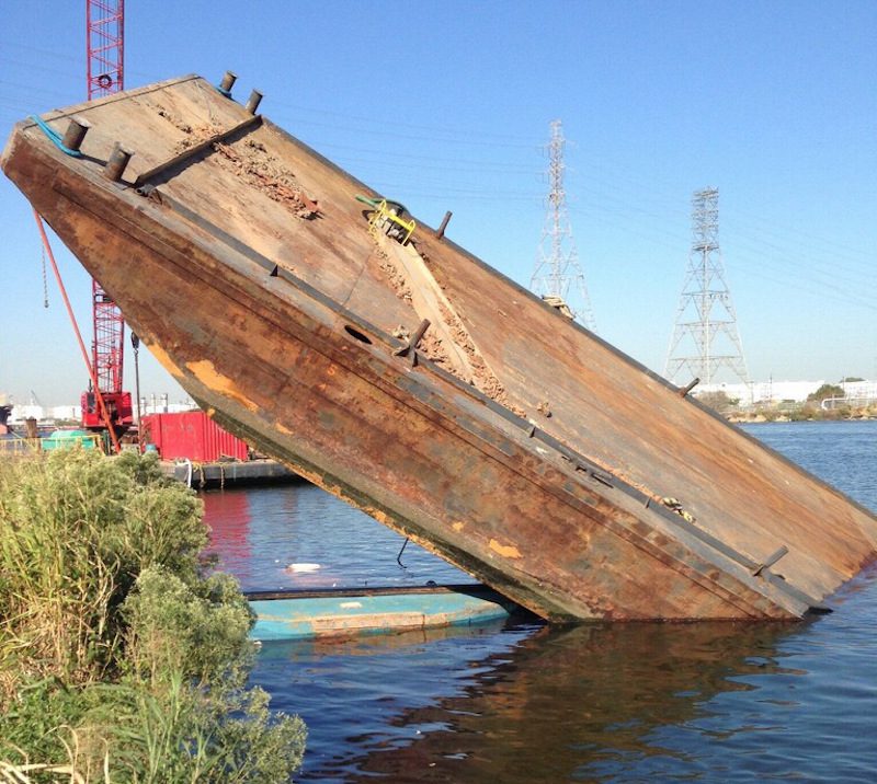 The Coast Guard closed a section of the Upper Houston Ship Channel Monday, Oct. 19, 2015, after the tug Annie Moon and attached barge sank across from the Kinder Morgan terminals in Galena Park. The barge was carrying 60 to 80 foot long sheets of two-foot wide metal.
