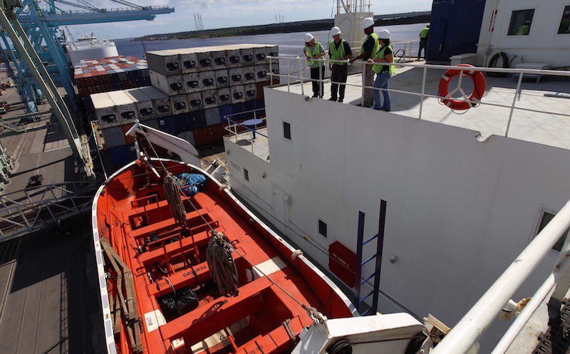 NTSB investigators inspect an open-top lifeboat onboard El Faro's sister ship, El