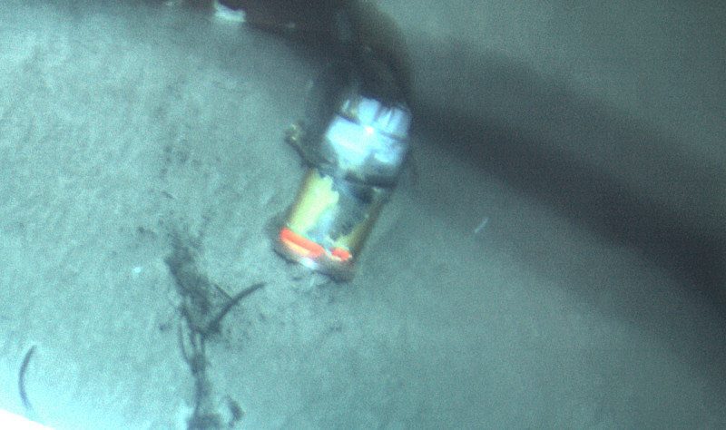 El Faro's VDR seen in the sand at a depth of 15,000 feet off the Bahamas. Photo credit: NTSB