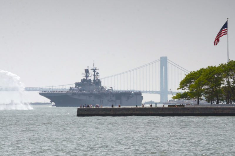 NEW YORK (May 25, 2016) The amphibious assault ship USS Bataan (LHD 5) transits between Liberty Island and the Verrazano Bridge during the Parade of Ships to kick off Fleet Week New York 2016. Fleet Week New York, now in its 28th year, is the city's time-honored celebration of the sea services. It is an unparalleled opportunity for the citizens of New York and the surrounding tri-state area to meet Sailors, Marines and Coast Guardsmen, as well as witness firsthand the latest capabilities of today's maritime services. (U.S. Navy photo by Chief Mass Communication Specialist Travis Simmons/Released)