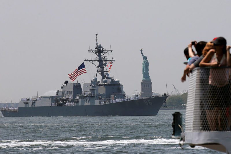 Tourists aboard a Statue of Liberty ferry watch as the Arleigh Burke-class guided missile destroyer, USS Bainbridge, arrives in New York Harbor to mark the beginning of Fleet Week in New York City, U.S., May 25, 2016. REUTERS/Brendan McDermid