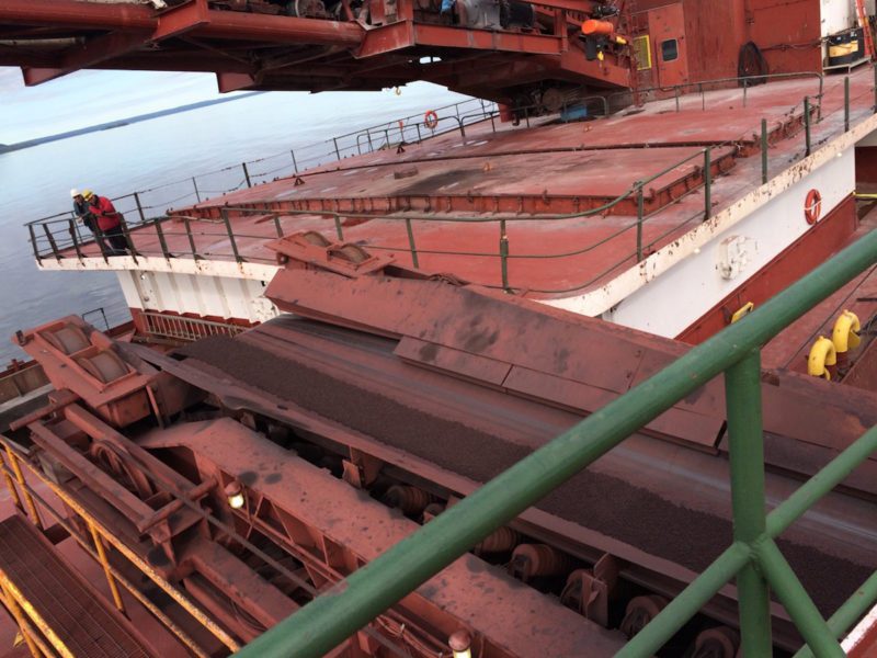 The motor vessel Phillip R. Clarke receives taconite by conveyor belt from the motor vessel Roger Blough that ran aground on May 27, near Gros Cap Reefs Light in Lake Superior, June 3, 2016. The Clarke is scheduled to remove some of the taconite from the Blough in order to lighten the Blough so it can be refloated. (U.S. Coast Guard photo by Craig Gorman)