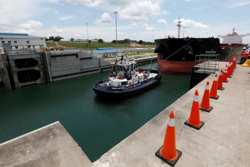 A tugboat drags a Post-Panamax cargo ship during the first trial run at the new sets of locks on the Atlantic side of the Panama Canal, in Panama City, Panama June 9, 2016. REUTERS/Carlos Jasso
