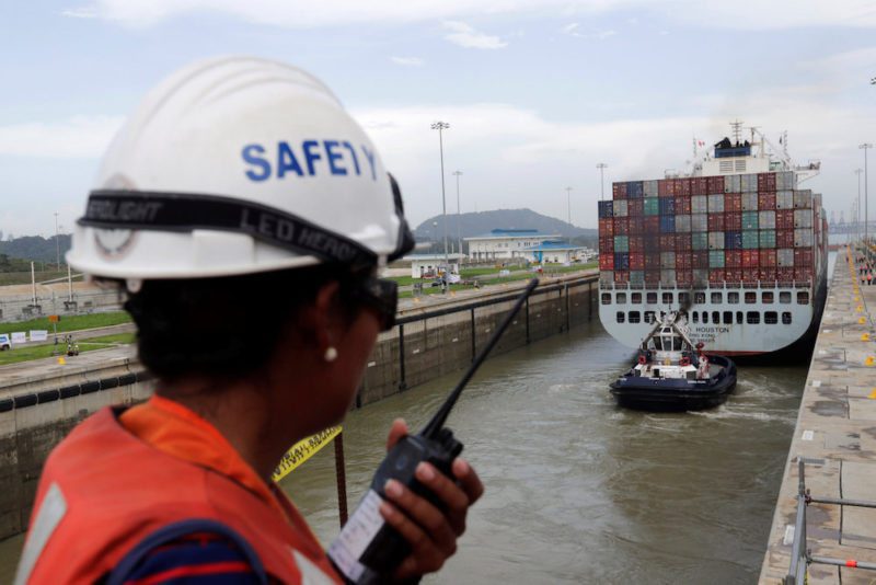 A worker talks on a walkie talkie as cargo ship named Cosco Houston, navigates through Cocoli locks during a test of the new set of locks of the Panama Canal expansion project on the Pacific side in Cocoli, on the outskirts of Panama City, Panama June 23, 2016.  REUTERS/Carlos Jasso