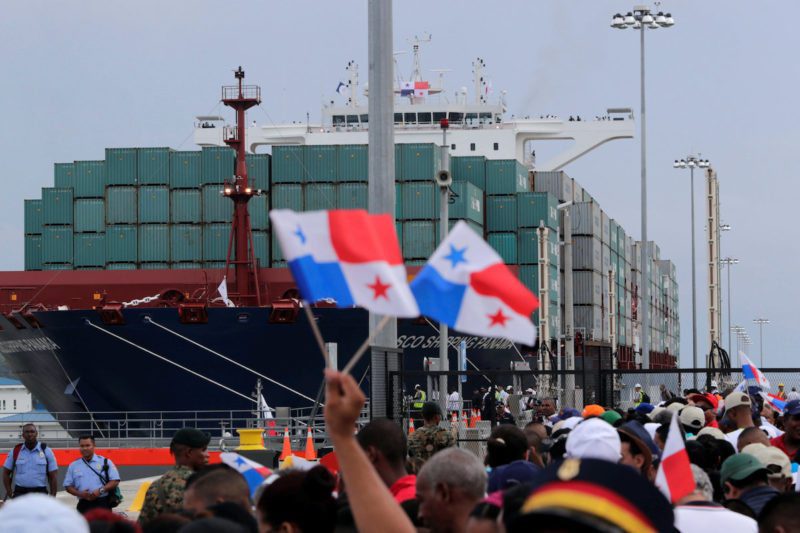 People wave Panama flags as they wait for the Chinese COSCO container vessel named Andronikos to navigate through the Agua Clara locks during the first ceremonial pass through the newly expanded Panama Canal, June 26, 2016. REUTERS/Carlos Jasso TPX IMAGES OF THE DAY